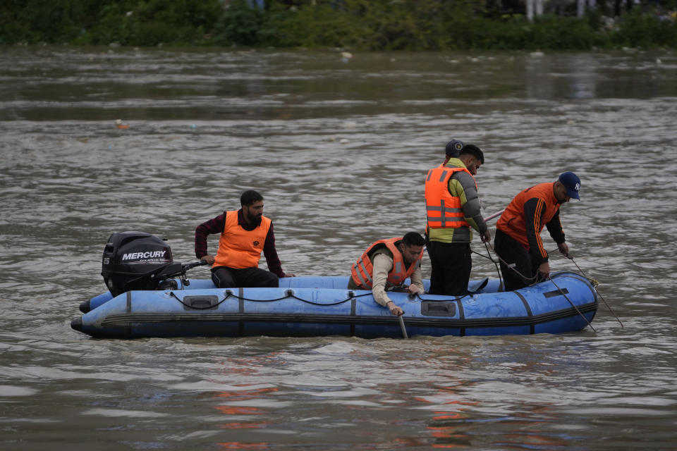 Rescuers of the National Disaster Response Force (NDRF) search after a boat carrying people including children capsized in Jhelum river on the outskirts of Srinagar, Indian controlled Kashmir, Tuesday, April. 16, 2024. Rescue operation is continuing for the several missing people. (AP Photo/Mukhtar Khan)