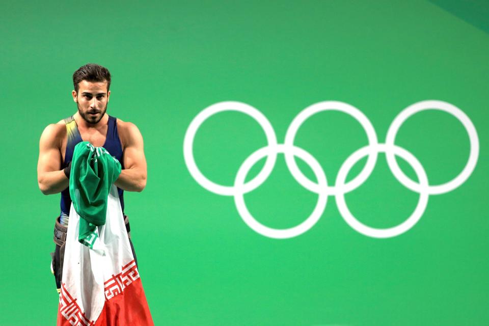<p>Rostami Kianoushof Iran sets a new world record and celebrates winning the gold medal during the Weightlifting – Men’s 85kg on Day 7 of the Rio 2016 Olympic Games at Riocentro – Pavilion 2 on August 12, 2016 in Rio de Janeiro, Brazil. (Photo by Mike Ehrmann/Getty Images) </p>