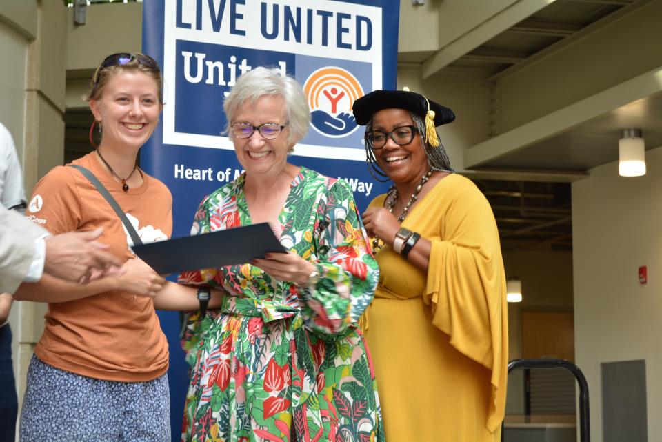 Heart of Missouri United Way Give 5 program graduate Paula Snyder, center, receives her certificate Thursday during a ceremony at Missouri Employers Mutual on Keene Street. She matched with the Columbia Center for Urban Agriculture for her five-hours-per-month volunteer commitment. She was joined by that organization's volunteer coordinator, Heidi Alleman, from left, and Eryca Neville, Heart of Missouri United Way board chair, who wore her doctoral graduation cap special for the event.