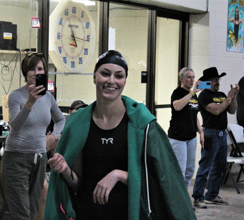 Maggie Jagger of Pueblo County smiles as she exits the pool after winning the 100-yard backstroke at the South-Central League finals held at Pueblo County High School on Feb. 4, 2023.