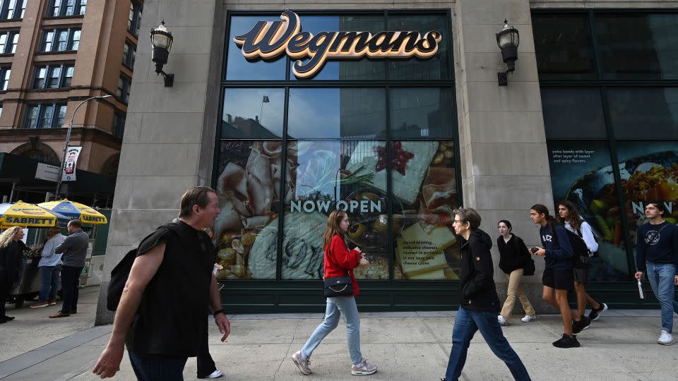 People walk by the Wegmans at Astor Place in Manhattan, New York, on October 19, 2023. - Anthony Behar/Sipa USA/AP