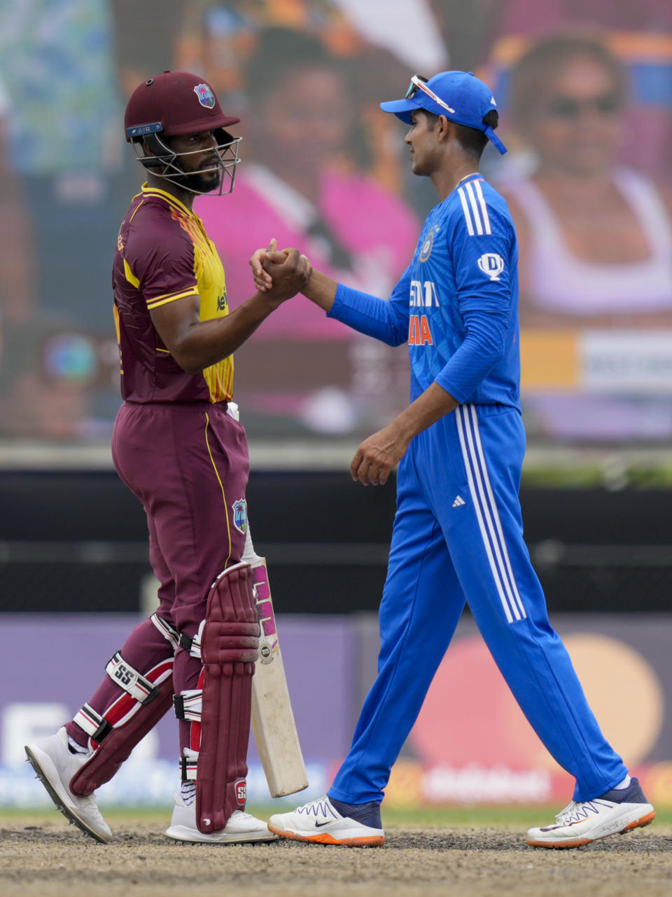 India's Shubman Gill shakes hands with West Indies' batsman Shai Hope during the fifth T20 cricket match at Central Broward Regional Park in Lauderhill, Fla, Sunday, Aug. 13, 2023. (AP Photo/Ramon Espinosa)