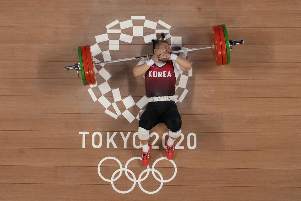 Kim Suhyeon of South Korea drops the barbel as she competes in the women's 76kg weightlifting event, at the 2020 Summer Olympics, Sunday, Aug. 1, 2021, in Tokyo, Japan. (AP Photo/Luca Bruno)