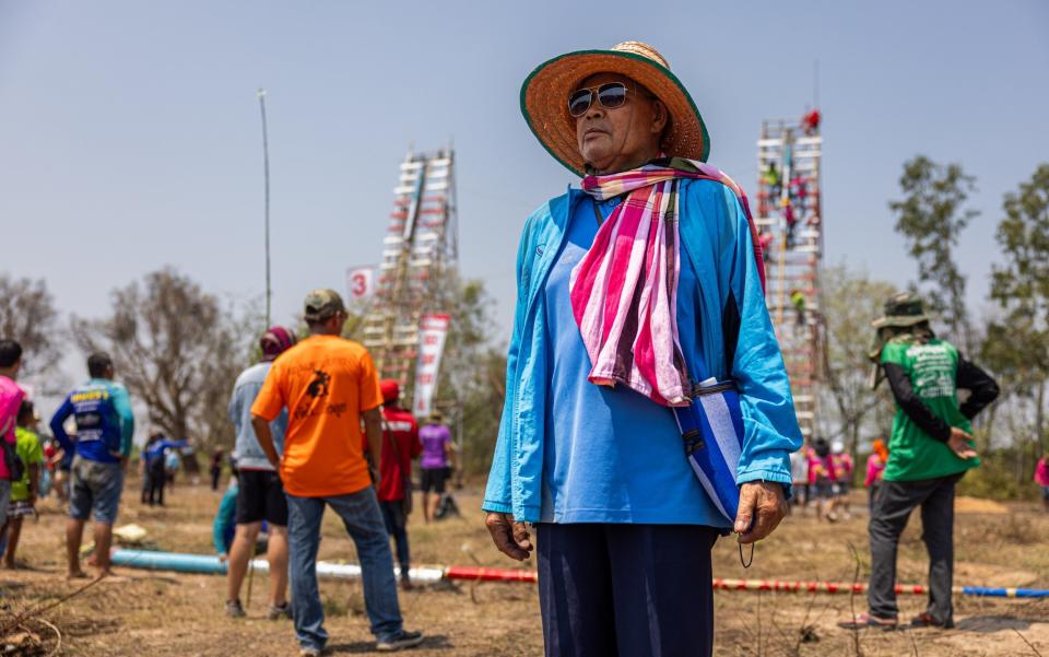 Brasart, 70, poses for a portrait in front of the rocket launch platforms during the 