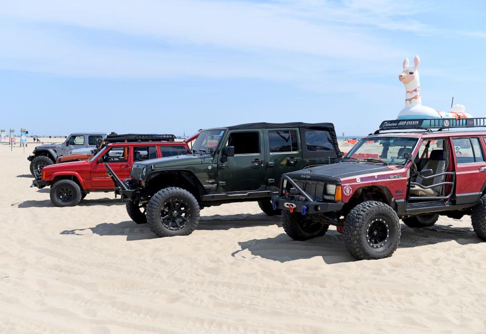 Jeeps take to the sand for a beach crawl Thursday, Aug. 25, 2022, in front of Somerset Plaza in Ocean City, Maryland.