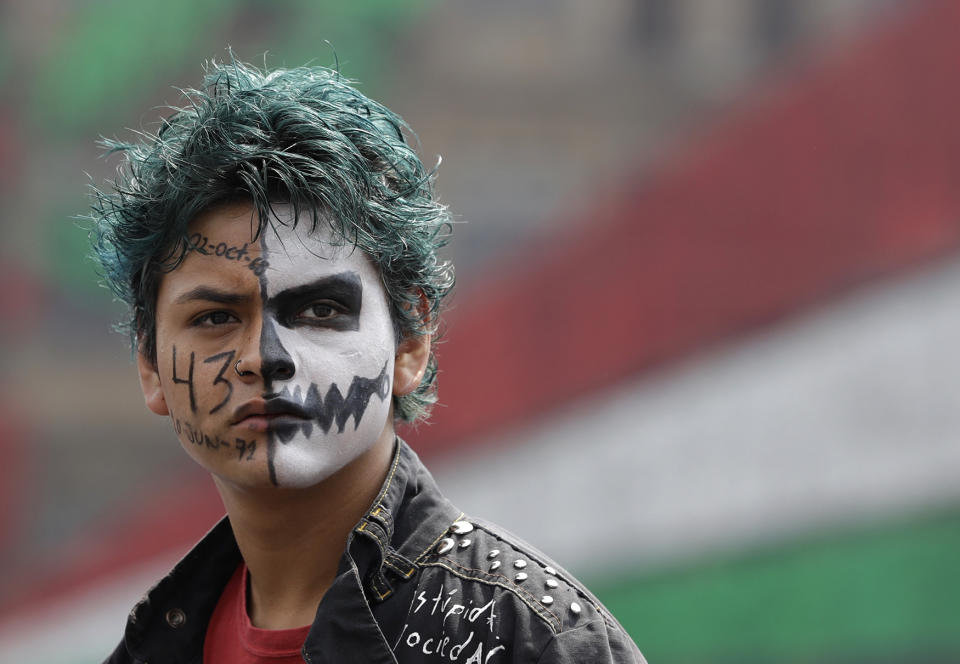 A protestor with a painted face participates in a march