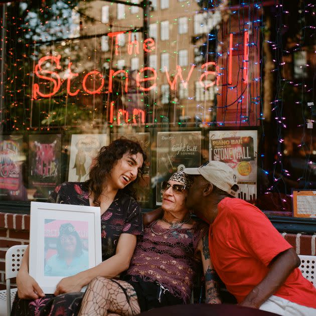 Lara, Reneé and Albert with a photo of Janice in front of The Stonewall Inn. (Photo: Yael Malka for HuffPost)