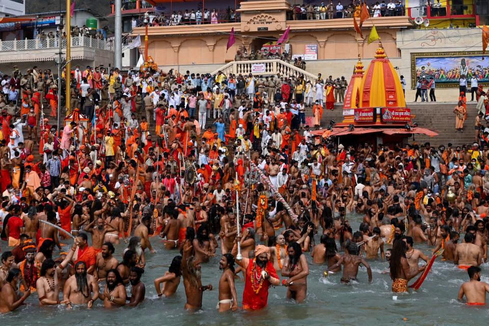 <p>Naga Sadhus (Hindu holy men) take a holy dip in the waters of the Ganges River during the ongoing religious Kumbh Mela festival, in Haridwar, as Covid-19 cases continue to surge in the country </p> (Getty Images)