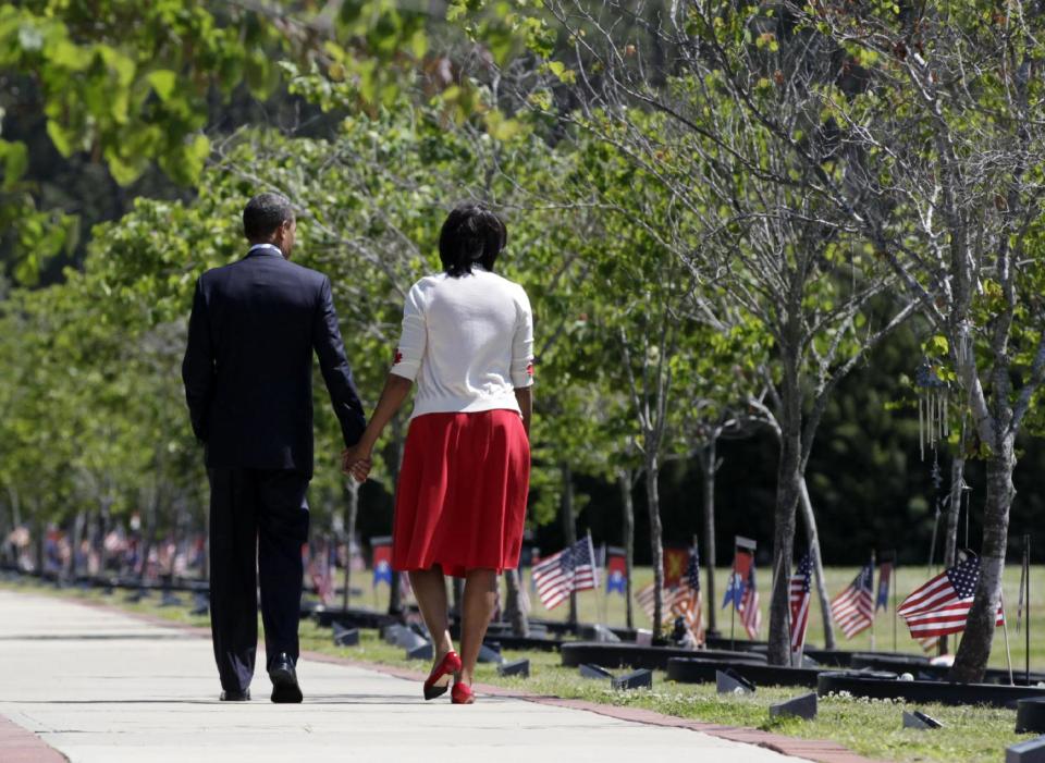 President Barack Obama and first lady Michelle Obama visit Warriors Walk at Fort Stewart, Ga., Friday, April 27, 2012, before speaking to troops, veterans and military families at the Third Infantry Division Headquarters. Warriors Walk pays tribute to the 441 fallen service members who have died in Operations Iraqi and Enduring Freedom and Operation New Dawn while assigned or attached to the 3rd Infantry Division or Fort Stewart and Hunter Army Airfield. Each fallen service member is honored with a plaque and an Eastern Redbud tree. (AP Photo/Carolyn Kaster)