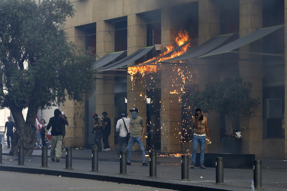 Anti-government protesters burn awnings of the Le Gray hotel during ongoing protests against the Lebanese government, in downtown Beirut, Lebanon, Saturday, June 6, 2020. Hundreds of Lebanese demonstrators gathered in central Beirut Saturday, hoping to reboot nationwide anti-government protests that began late last year amid an unprecedented economic and financial crisis. (AP Photo/Bilal Hussein)