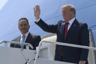 FILE - In this Wednesday, Aug. 21, 2019 file photo, President Donald Trump, right, talks with Kentucky Gov. Matt Bevin, left, as they walk down down the steps of Air Force One at Louisville International Airport in Louisville, Ky. For Republicans who've been working to nationalize their races all along, the impeachment news couldn't have come at a better time. In Kentucky, gubernatorial candidate Andy Beshear is locked in a close race with Bevin, a Trump loyalist with a slash-and-burn style similar to the president's. (AP Photo/Susan Walsh, File)