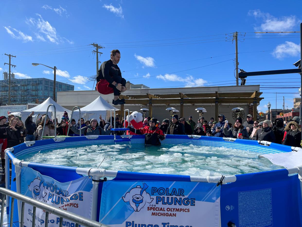 Miles Macik of Northville jumps into a pool of icy water for the Polar Plunge fundraiser at the Winter Blast festival in Royal Oak on Saturday, February 19.