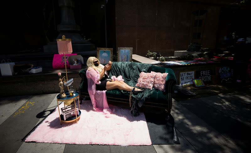 A supporter lays on a couch during a rally for pop star Britney Spears during a conservatorship case hearing at Stanley Mosk Courthouse in Los Angeles