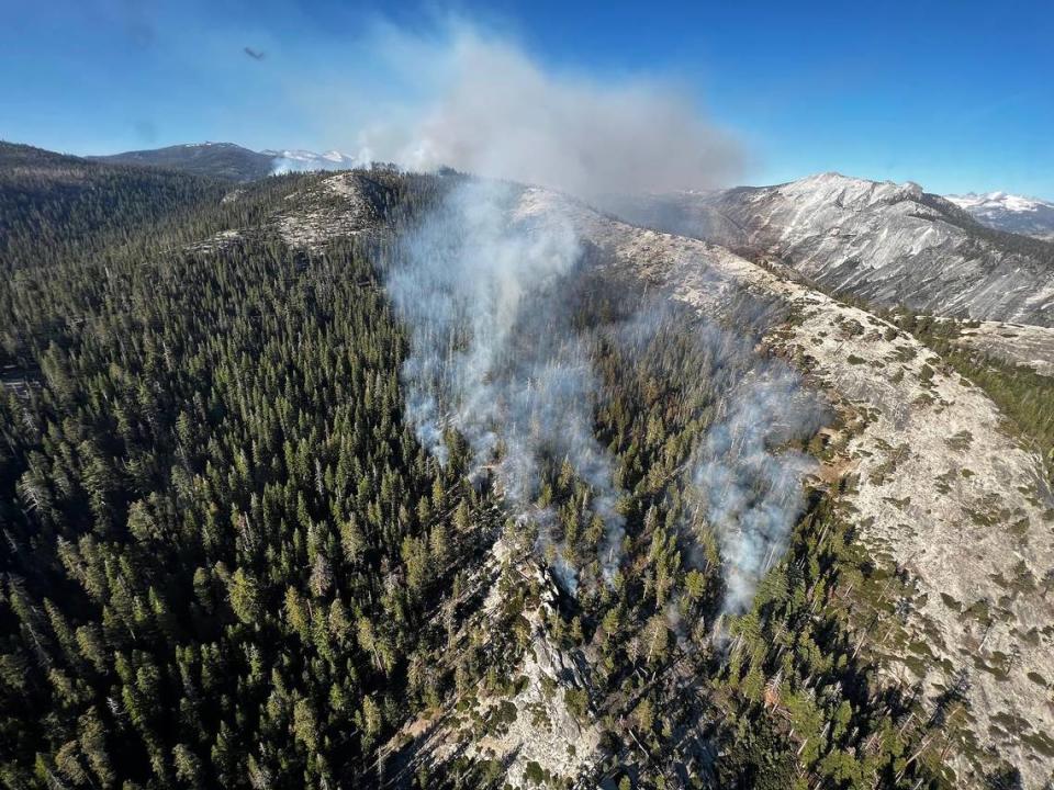 Smoke rises from a wildfire at Yosemite National Park, just west of North Dome that was sparked by lightning on June 29, 2023. Yosemite Fire and Aviation