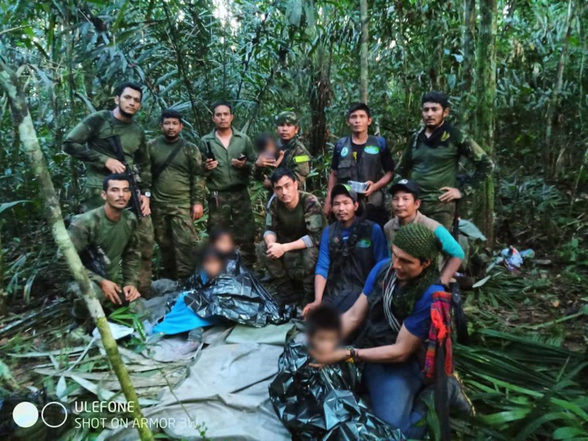 In this handout picture released by the Colombian Presidency members the Army pose four Indigenous children after spending more than a month lost in the Colombian Amazon rainforest following a small plane crash, in Colombia's Guaviare jungle on June 9, 2023 (Colombian Presidency/AFP via Get)