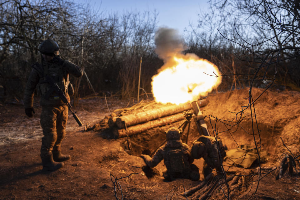Ukrainian servicemen fire by a Finnish 120 mm mortar towards Russian positions at the frontline near Bakhmut, Donetsk region, Ukraine, Wednesday, Jan. 11, 2023. (AP Photo/Evgeniy Maloletka)