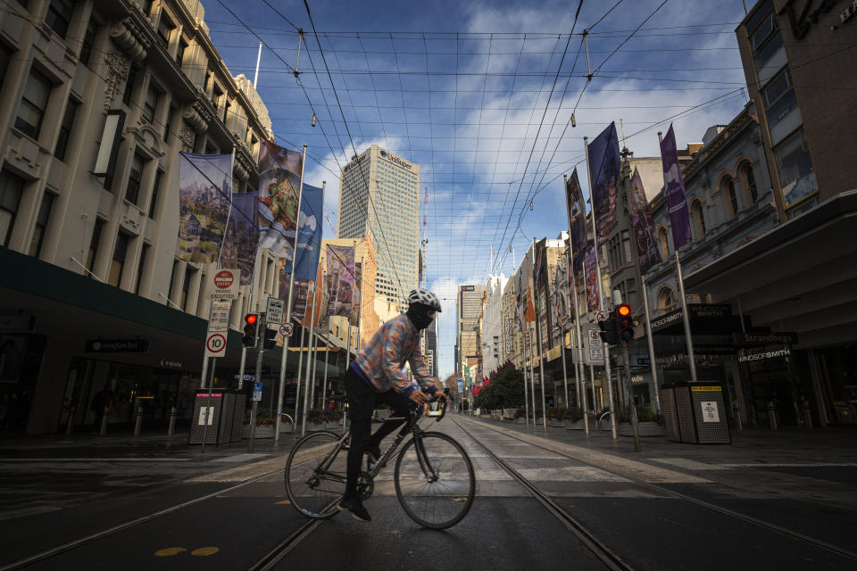 A bike rider on the empty streets at Bourke Street in Melbourne.