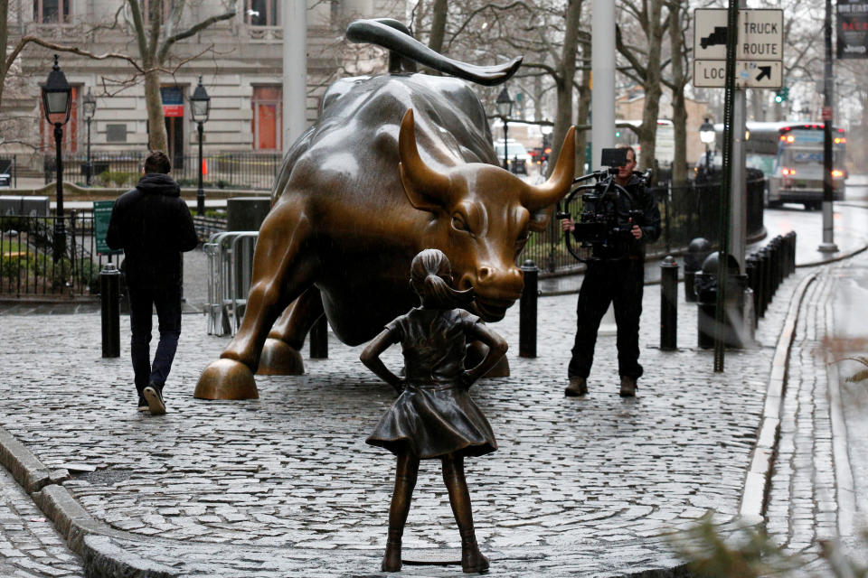 FTSE 100 A camera man films a statue of a girl facing the Wall St. Bull, as part of a campaign by U.S. fund manager State Street to push companies to put women on their boards, in the financial district in New York, U.S., March 7, 2017. REUTERS/Brendan McDermid