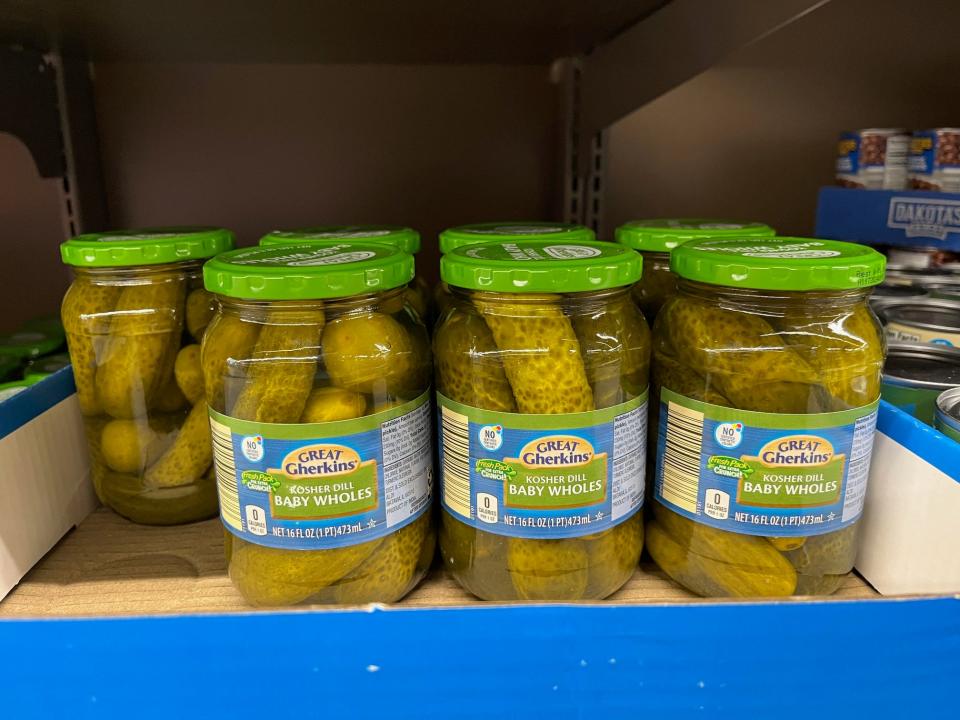 Jars of kosher dill baby whole pickles in boxes at Aldi.