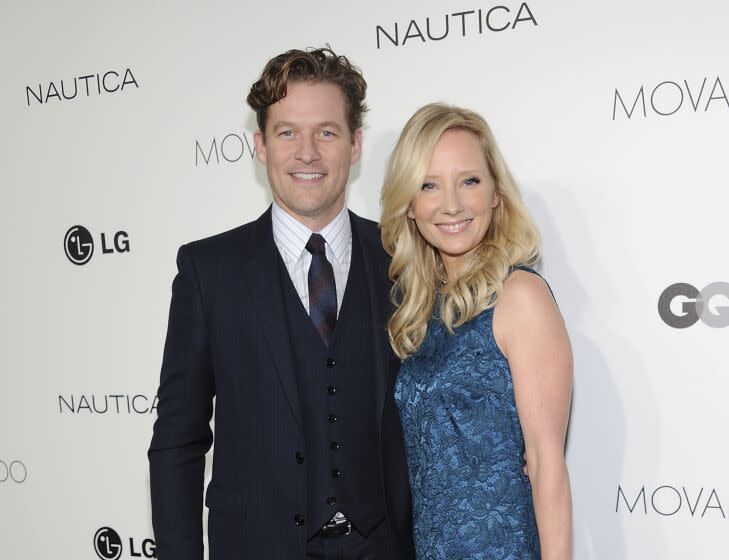 FILE - Actors James Tupper, left, and Anne Heche attend the The 2012 Gentlemen's Ball hosted in New York on Oct. 24, 2012. Heche, who first came to prominence on the NBC soap opera "Another World" in the late 1980s before becoming one of the hottest stars in Hollywood in the late 1990s, died Sunday, Aug. 14, 2022, nine days after she was injured in a fiery car crash. She was 53. (Photo by Evan Agostini/Invision/AP, File)