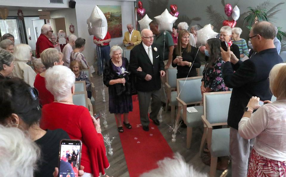 Marie & Mike Helland make their way down the aisle on Valentine's Day to join four other couples renewing their marriage vows at CountySide Lakes Senior Living in Port Orange. The key to a long marriage, according to Marie: "“You have to talk about everything. Nothing goes unsaid.”