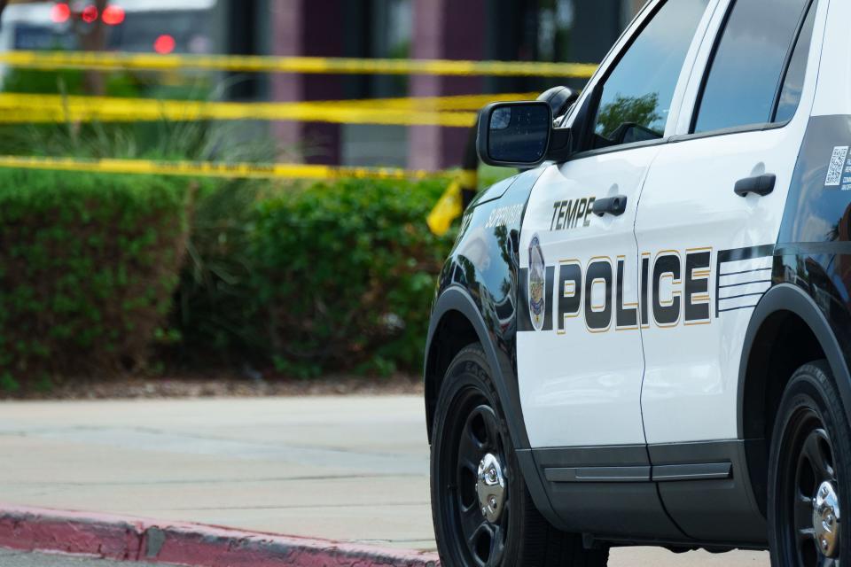 Tempe police officers close off a section of a shopping center near the intersection of Baseline and Rural roads in Tempe as an investigation takes place on Aug. 14, 2023.