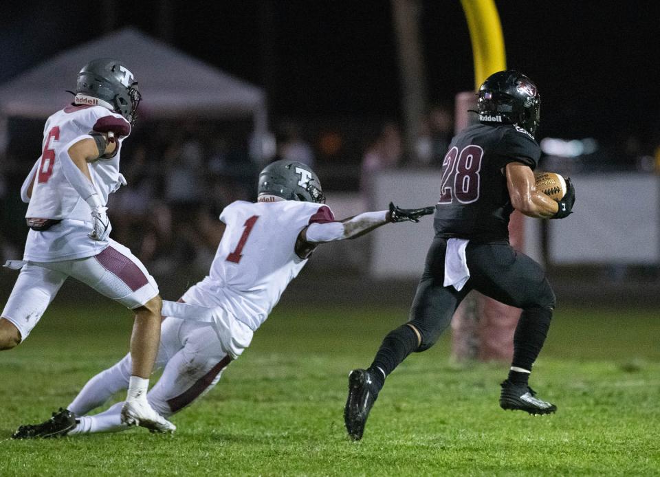 Connor Mathews (28) gets past the last Aggies defender on a long run to the house to cut the Aggies lead to 14-13 during the Tate vs Navarre football game at Navarre High School on Friday, Sept. 15, 2023.