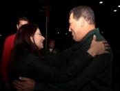 FILE PHOTO: Venezuela's President Chavez embraces National Assembly President Flores before a meeting with United Socialist party members in Caracas