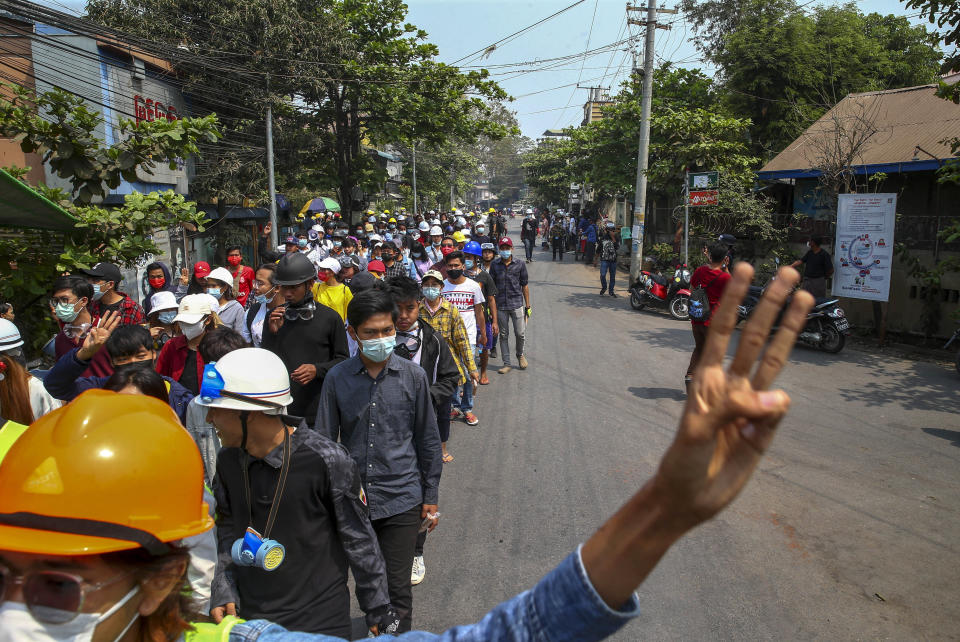 Anti-coup protesters walk to take positions in Mandalay, Myanmar, Tuesday, March 9, 2021. Demonstrators in Myanmar's biggest city came out Monday night for their first mass protests in defiance of an 8 p.m. curfew, seeking to show support for an estimated 200 students trapped by security forces in a small area of one neighborhood. (AP Photo)