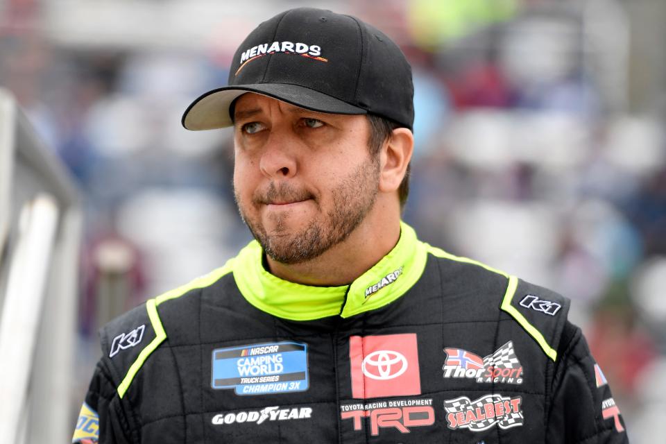 Matt Crafton, driver of the #88 Black Label Bacon/Menards Toyota, walks on stage during pre-race ceremonies prior to the NASCAR Camping World Truck Series United Rentals 200 at Martinsville Speedway on October 30, 2021 in Martinsville, Virginia.