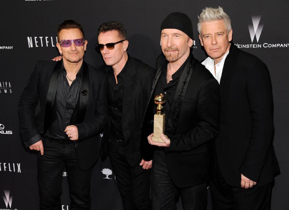 FILE - In this Jan. 12, 2014 file photo, from left, Bono, Larry Mullen, Jr., The Edge and Adam Clayton, of the Irish band U2, winners of the award for best original song for "Ordinary Love" from the film "Mandela: Long Walk to Freedom," arrive at The Weinstein Company's Golden Globes after party at the Beverly Hilton Hotel in Beverly Hills, Calif. U2, Pharrell Williams, Karen O and Idina Menzel are slated to perform the nominated original songs at the 86th Academy Awards on Sunday, March 2, 2014. Bette Midler and Pink are also set to perform. (Photo by Chris Pizzello/Invision/AP, file)