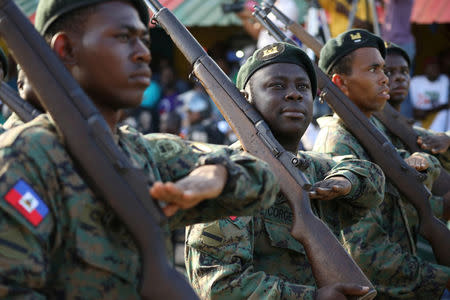 Members of the Haitian Armed Forces (FAD'H) salute as they parade in the streets of Cap-Haitien, Haiti, November 18, 2017. REUTERS/Andres Martinez Casares