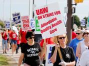 FILE PHOTO: Striking General Motors Detroit-Hamtramck Assembly plant workers and their supporters walk the picket line during the United Auto Workers (UAW) national strike in Hamtramck, Michigan,