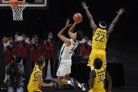 Virginia's Justin McKoy, center, shoots past Towson's Solomon Uyaelunmo, right, in the first half of an NCAA college basketball game, Wednesday, Nov. 25, 2020, in Uncasville, Conn. (AP Photo/Jessica Hill)