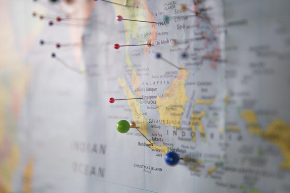 BudgetAir is an international travel agency that has acquired a dodgy reputation but still is a popular tool for travelers. 
pictured: a paper map of the world with pins stuck in different locations and countries 