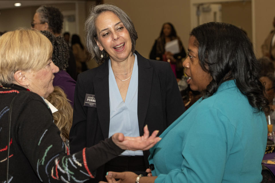 Kathy Telban, from left, of Mayfield His. Ohio, speaks with Lisa Forbes, the Democratic candidate for the Ohio Supreme Court and Angel Washington, a candidate for Ohio state representative, at the Women's Empowerment Luncheon in Richmond Heights, Ohio, Saturday, March 9, 2024. The Ohio Supreme Court’s 4-3 Republican majority could flip to Democrats’ favor in the fall if the party sweeps the three seats up for election this year. (AP Photo/Phil Long)