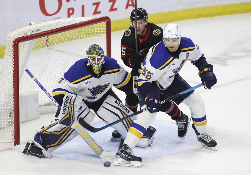 St. Louis Blues goaltender Thomas Greiss (1) and defenseman Colton Parayko (55) and Ottawa Senators' Parker Kelly (45) watch the puck during the third period of an NHL hockey game Sunday, Feb. 19, 2023, in Ottawa, Ontario. (Patrick Doyle/The Canadian Press via AP)