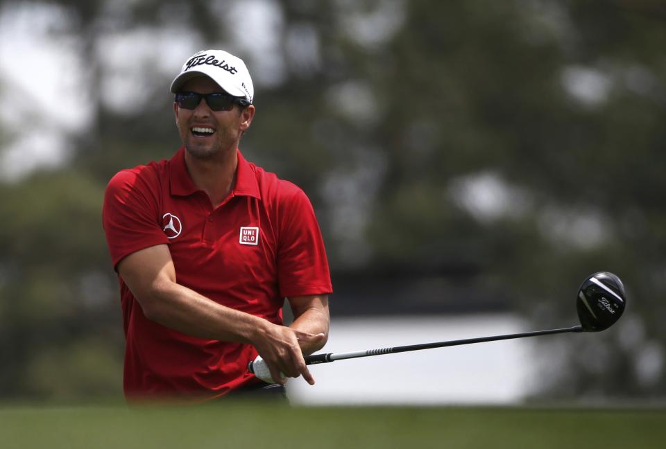 Australia's Adam Scott reacts after hitting his drive on the first hole into the sand trap during the second round of the Masters golf tournament at the Augusta National Golf Club in Augusta, Georgia April 11, 2014. REUTERS/Mike Segar (UNITED STATES - Tags: SPORT GOLF)