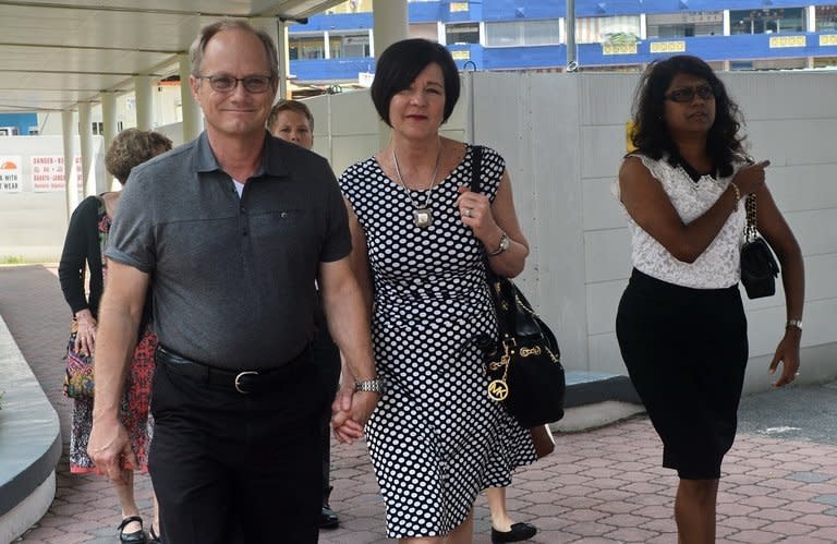 Rick Todd (L) and his wife Mary (C), the parents of US scientist Shane Todd, return to court in Singapore with their family lawyer Gloria James, on May 15, 2013. Singapore has asked the parents of Todd, found hanged last year in the city-state, to provide evidence for their claim that he was murdered, rather than committing suicide as medical experts said