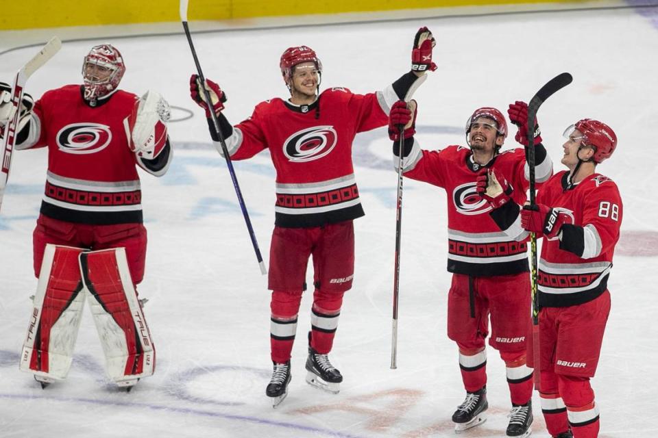 The Carolina Hurricanes, Frederik Andersen (31), Jesperi Kotkaniemi (82), Seth Jarvis (24) and Martin Necas (88) celebrate their 3-2 overtime victory against the New Jersey Devils, clinching their second round Stanley Cup series and advancing to the Eastern Conference Finals on Thursday, May 11, 2023 at PNC Arena in Raleigh, N.C.
