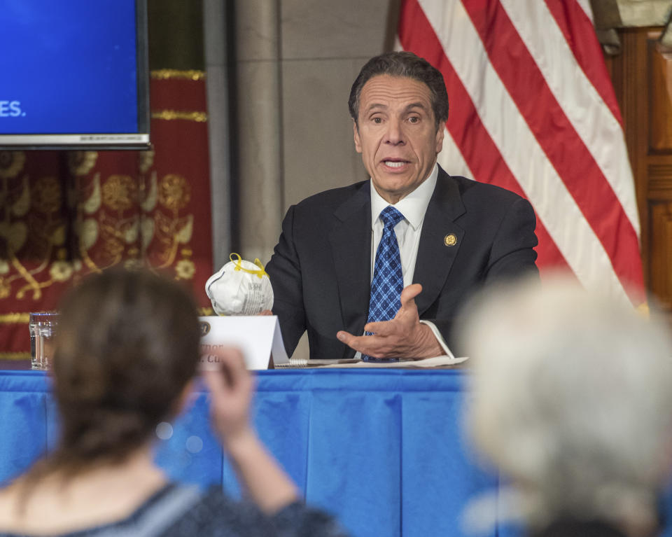 In this April 24, 2020 photo provided by the Office of Governor Andrew M. Cuomo, Gov. Cuomo addresses the media while holding an n95 mask during his daily press briefing on COVID-19, Coronavirus, at the State Capitol in Albany, N.Y. The mask was sent to the governor by a retired farmer from Kansas whose wife only has one lung. (Darren McGee/Office of Governor Andrew M. Cuomo via AP)