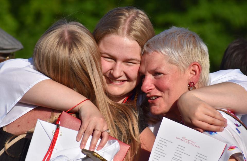 Bishop Connolly High School graduate Molly Jane Sandborg hugs sister Anna and mom Sally at her graduation ceremony on Wednesday, May 31, 2023.