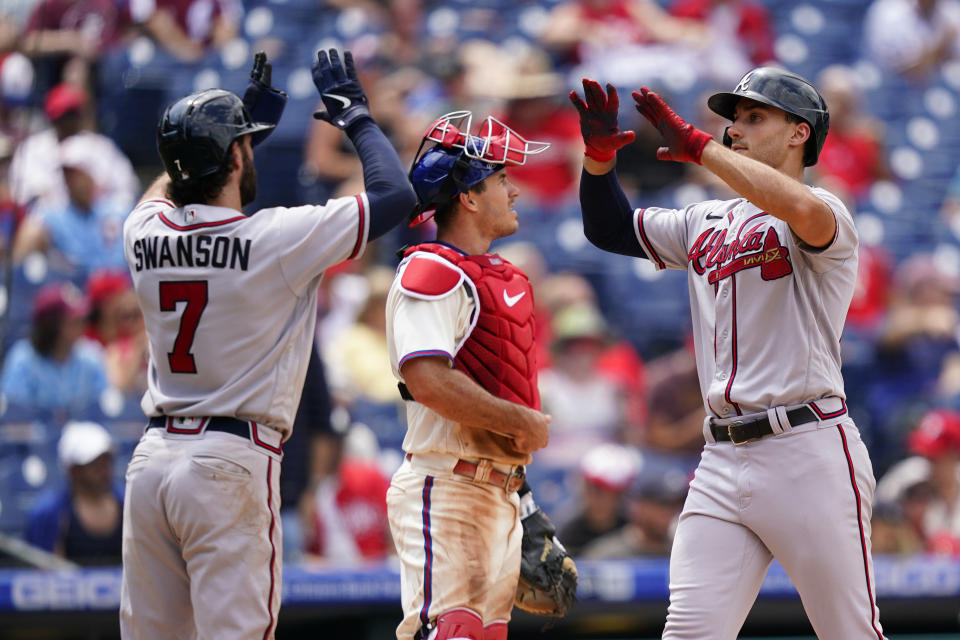 Atlanta Braves' Matt Olson, right, celebrates with Dansby Swanson, left, after hitting a two-run home run against Philadelphia Phillies pitcher Kyle Gibson during the sixth inning of a baseball game, Wednesday, July 27, 2022, in Philadelphia. (AP Photo/Matt Slocum)