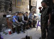 Free Syrian Army fighters rest as they drink tea in the old city of Aleppo September 10, 2013. REUTERS/Nour Kelze