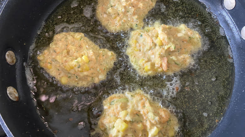 corn fritters frying in canola oil 