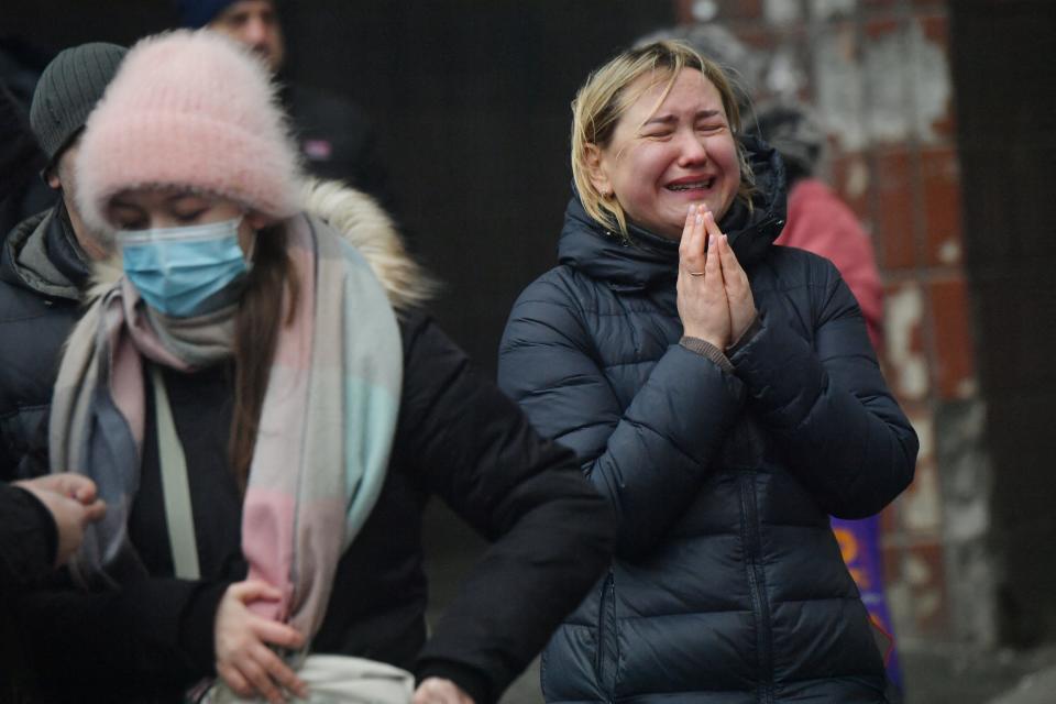 A local resident reacts outside a building damaged as a result of missile attack in Kyiv on February 7, 2024, amid the Russian invasion of Ukraine. At least three people were killed in a "massive" wave of Russian missile and drone attacks across Ukraine early on February 7, 2024, President Volodymyr Zelensky said.