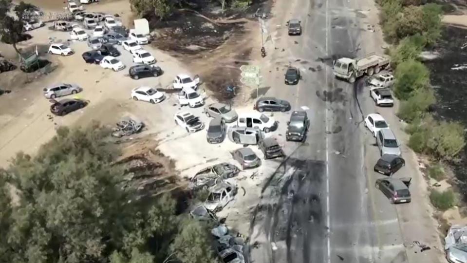 Drone video footage taken on Sunday shows burned-out cars on the side of the road near an open-air music festival in Israel where Hamas gunmen fired on those attending on Saturday. 