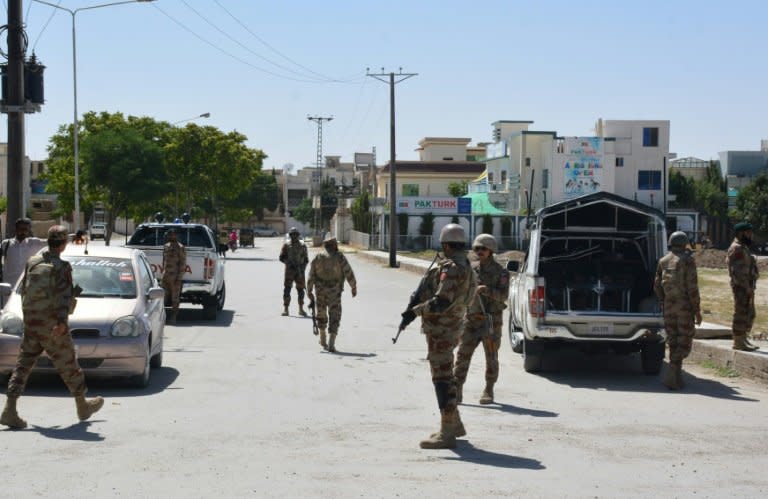 Pakistani soldiers stand guard at the site where a Chinese couple was kidnapped in the neighbourhood of Jinnah town in Quetta on May 24, 2017