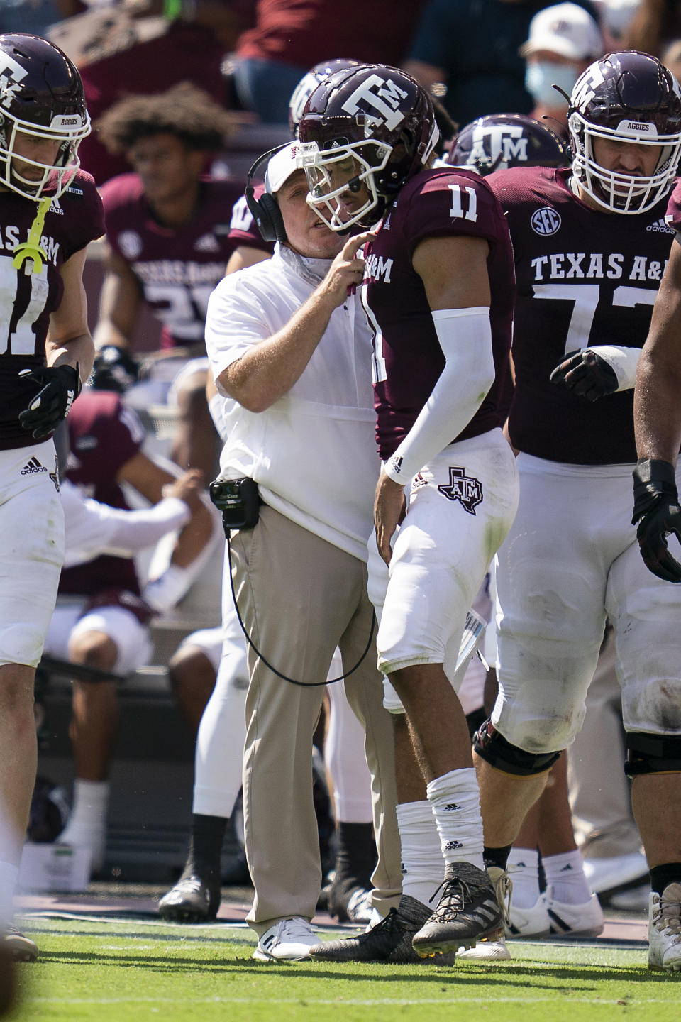 Texas A&M head coach Jimbo Fisher talks to quarterback Kellen Mond (10) during the first half of an NCAA college football game against Florida, Saturday, Oct. 10, 2020, in College Station, Texas. (AP Photo/Sam Craft)