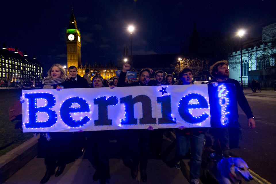 LONDON, ENGLAND - MARCH 01: Supporters of American Democrat candidate Bernie Sanders carry a sign with the slogan 'Bernie 2016' as they march to a local polling station during a Super Tuesday rally in Parliament Square on March 1, 2016 in London, England. Super Tuesday is a day in the United States presidential primary season where a large number of states hold their primary elections. American citizens abroad are allowed to vote for their chosen candidate at local polling centres.  (Photo by Ben Pruchnie/Getty Images)